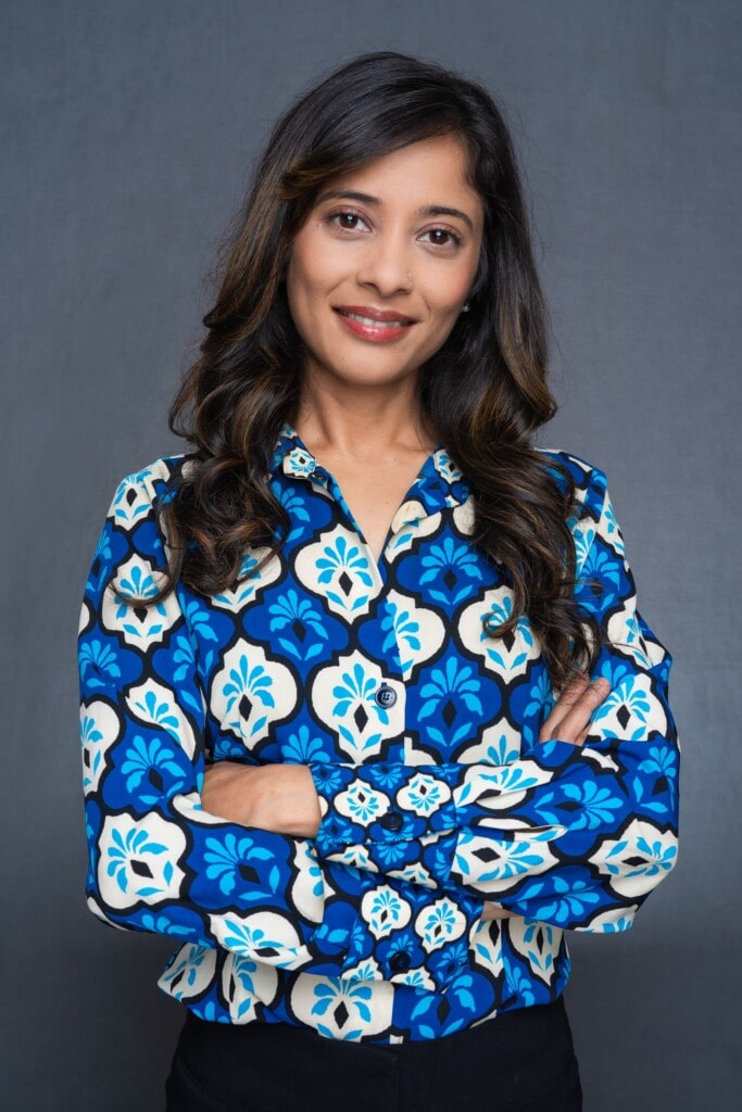Female-HR-Manager-Headshot-Sydney-NSW Int: Young Indian woman wearing a blue skirt having LinkedIn headshot taken by Professional Photographer Georgie Greene in Sydney NSW