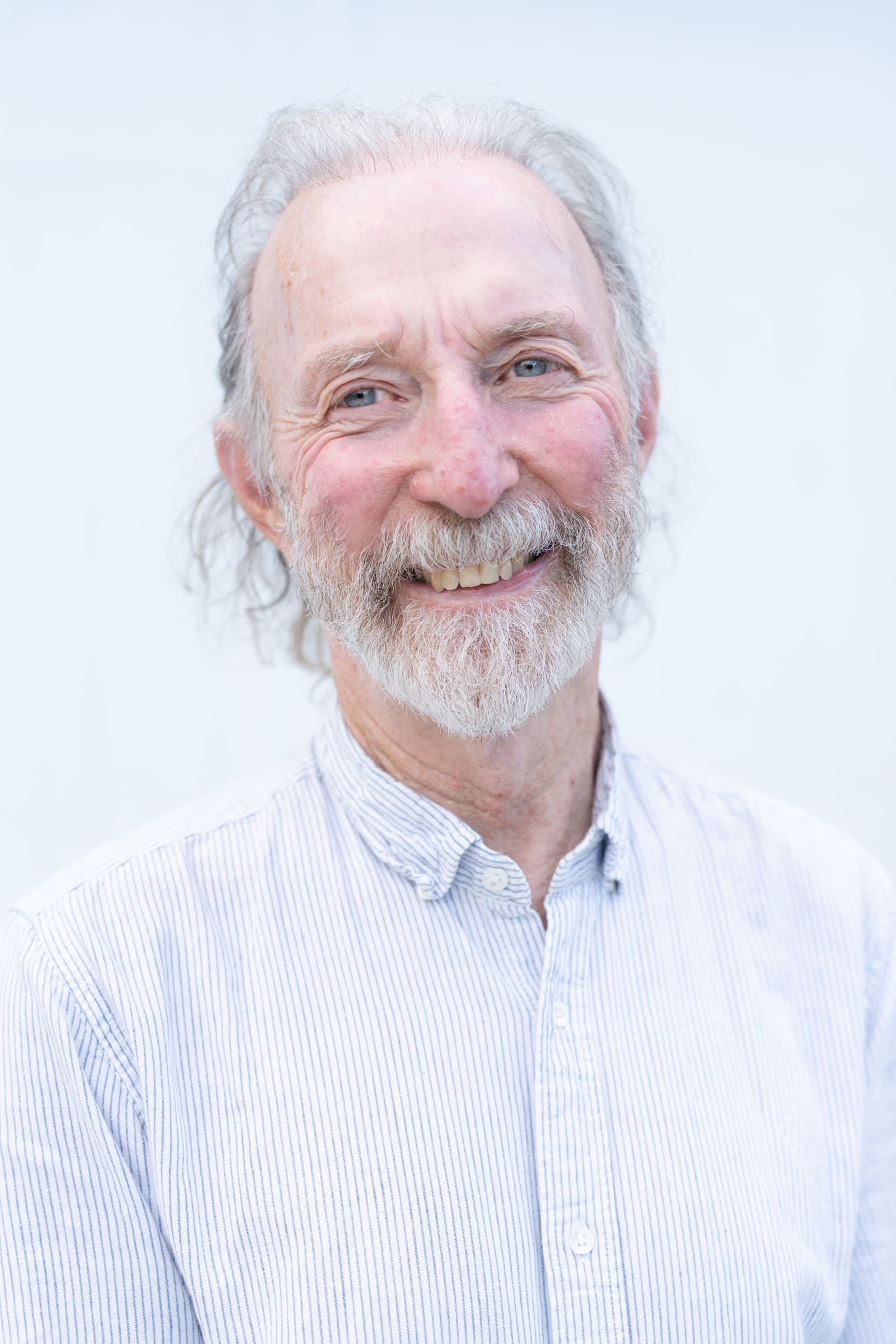 Natural-Light-Headshot-Older-Man older man with white hair and a beard having his portrait taken by professional photographer Georgie Greene in Sydney NSW
