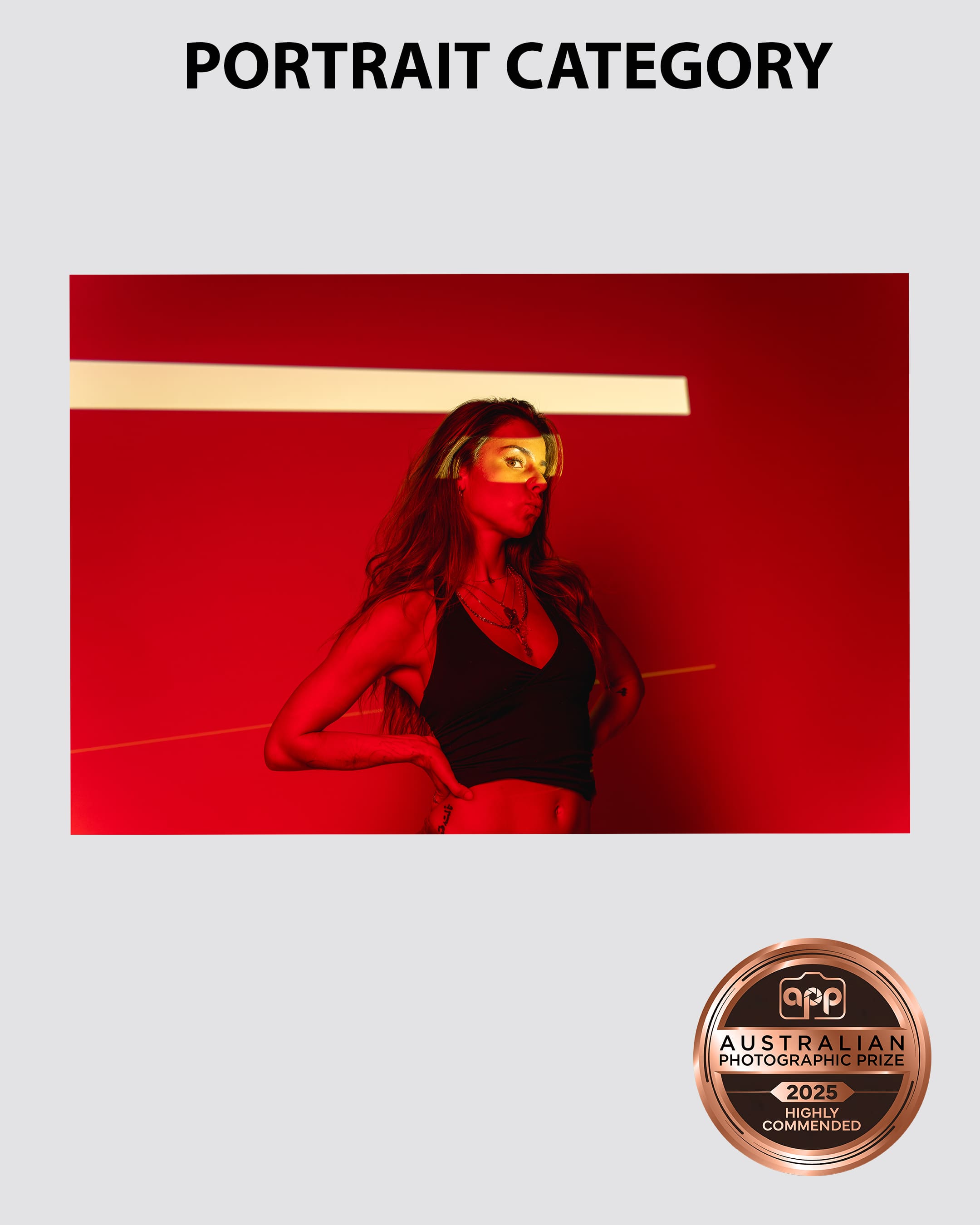Australian-Photographic-Prize-2025-Portrait-Category-Sydney Portrait of a model bathed in red light as she blows a kiss taken by Sydney professional photographer Georgie Greene