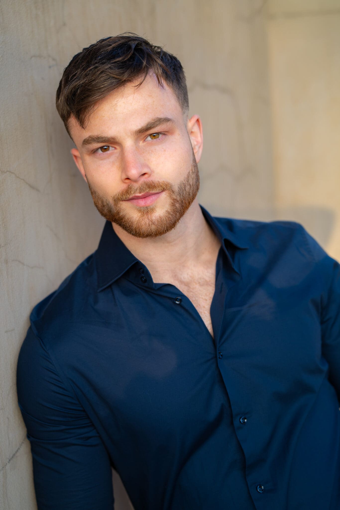 Young man in a blue shirt having his actor headshot taken by Sydney photographer Georgie Greene
