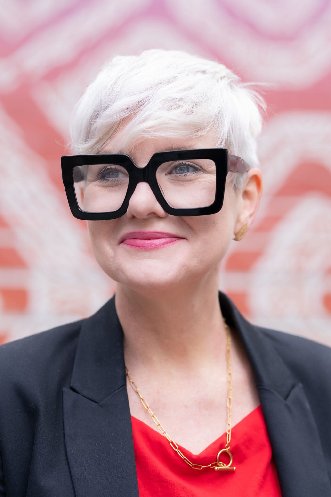 white haired woman wearing wearing big glasses having her headshot photos taken by photographer Georgie Greene in Sydney NSW