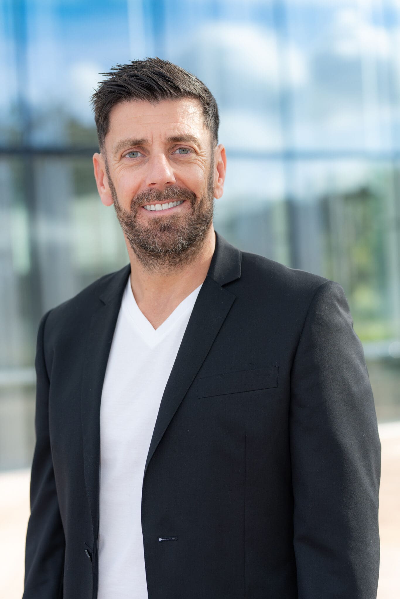 Middle-aged man wearing a black jacket having his headshot taken by Sydney professional photographer Georgie Greene