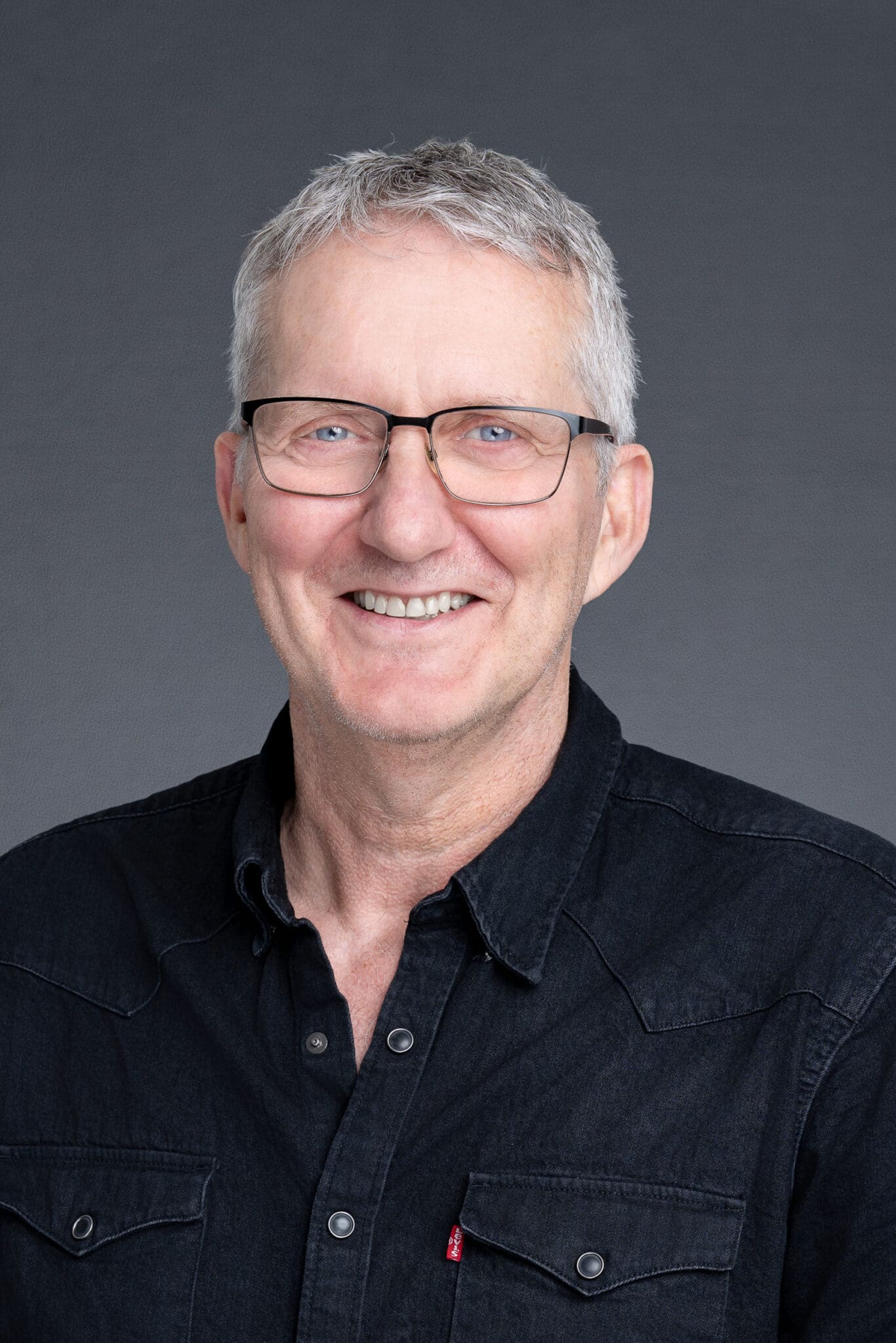 Middle-aged man wearing a black shirt having his headshot taken by Sydney portrait photographer Georgie Greene