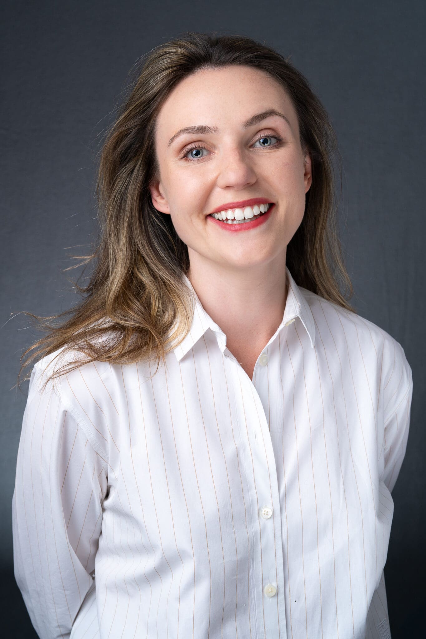 Young woman in a white top having your branding headshot taken by professional photographer Georgie Greene Sydney NSW