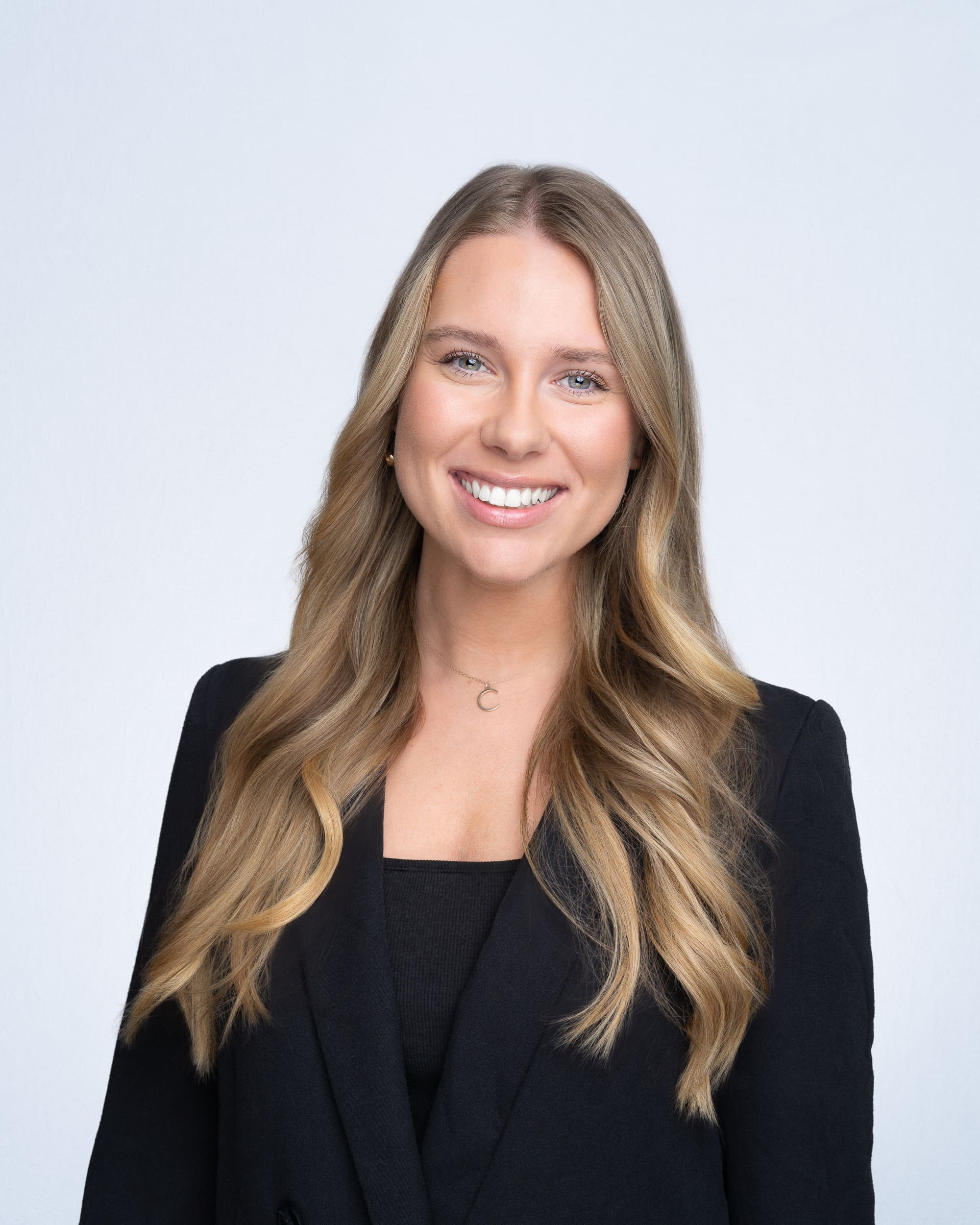 Company-Headshots-Sydney-NSW Young blonde woman wearing a black jacket having her company headshot taken by Sydney professional photographer Georgie Greene
