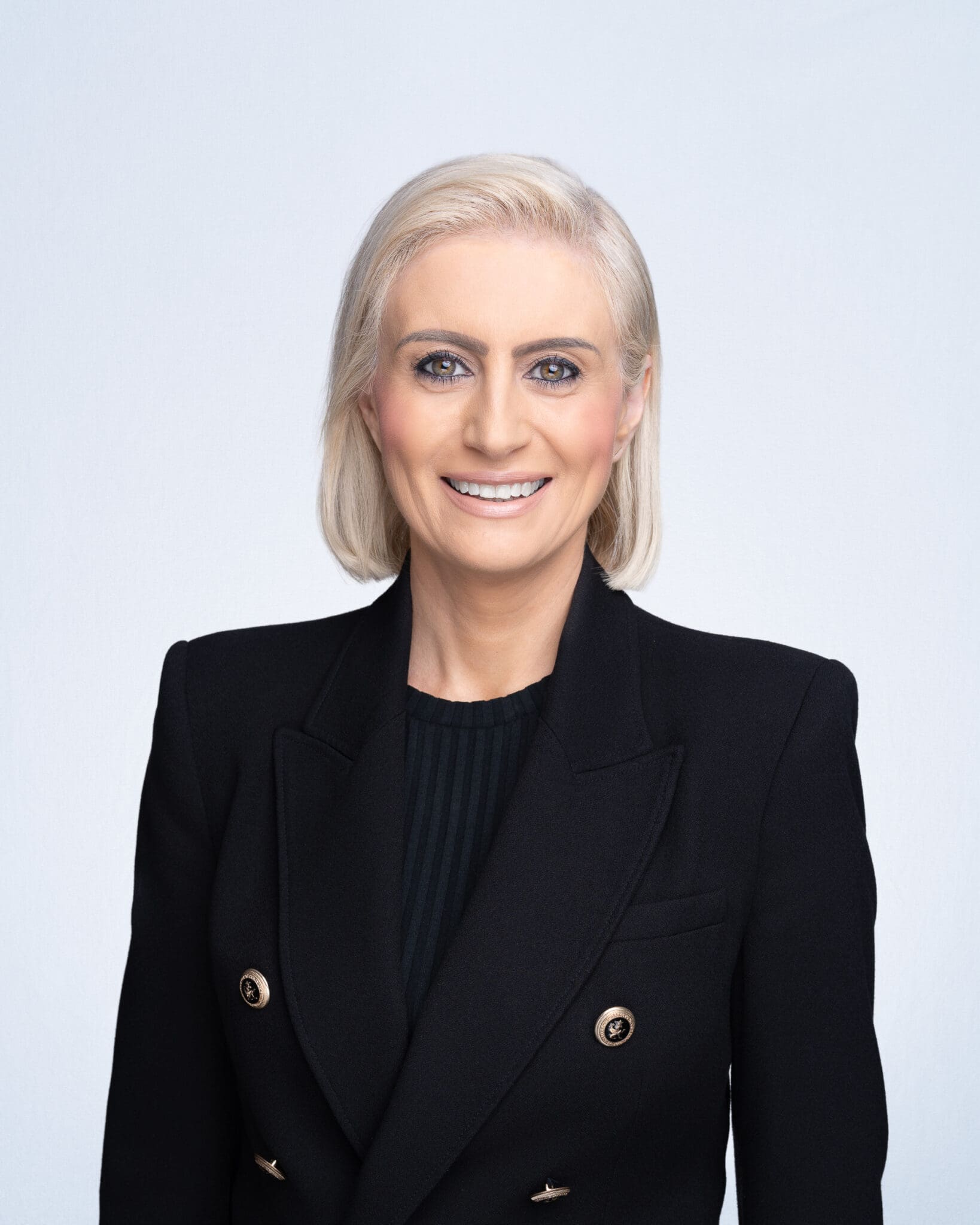 Young woman wearing a black blazer having her company headshot taken by Sydney corporate photographer Georgie Greene