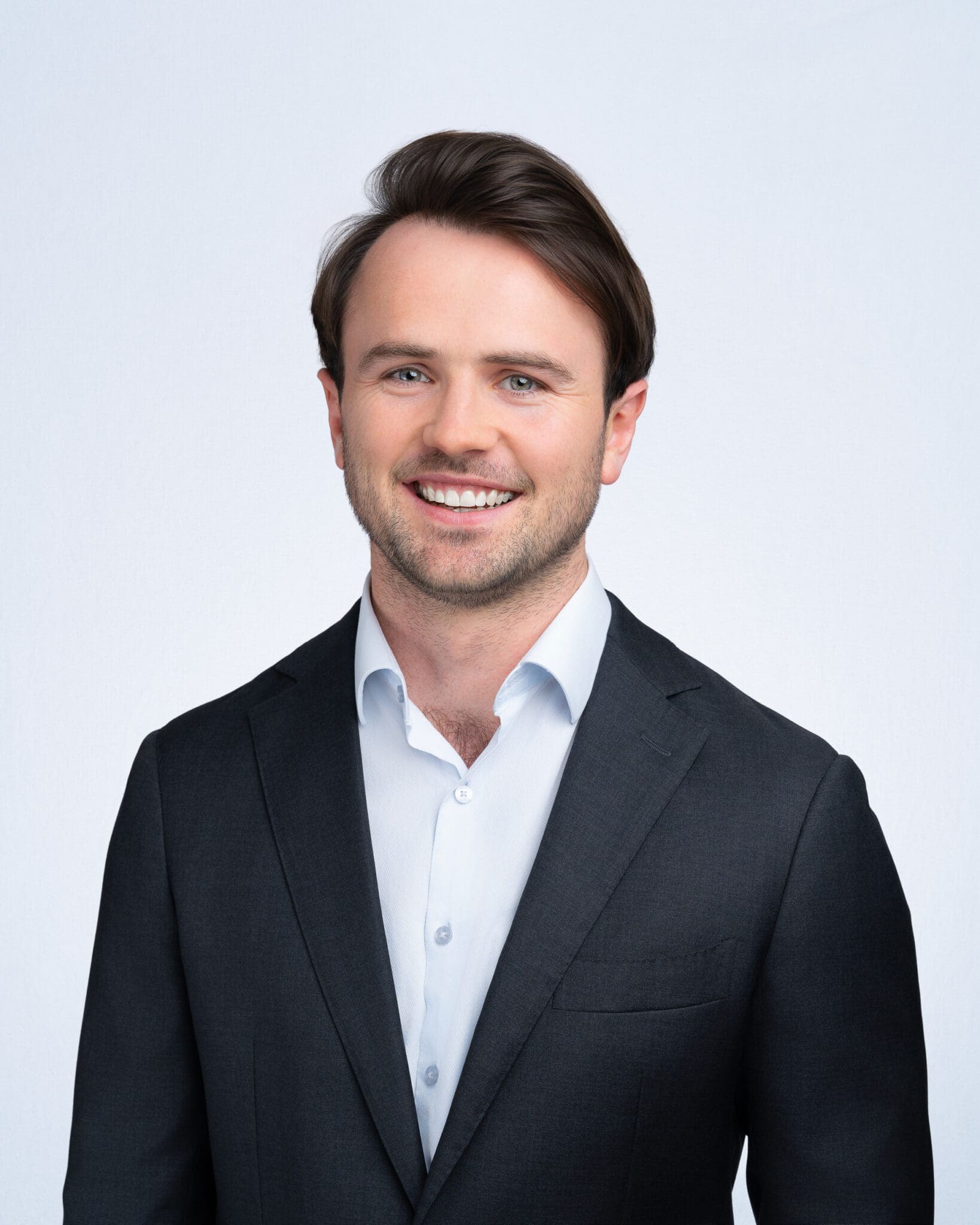 Young man wearing a blue jacket having his company headshot taken by Sydney headshot photographer Georgie Greene