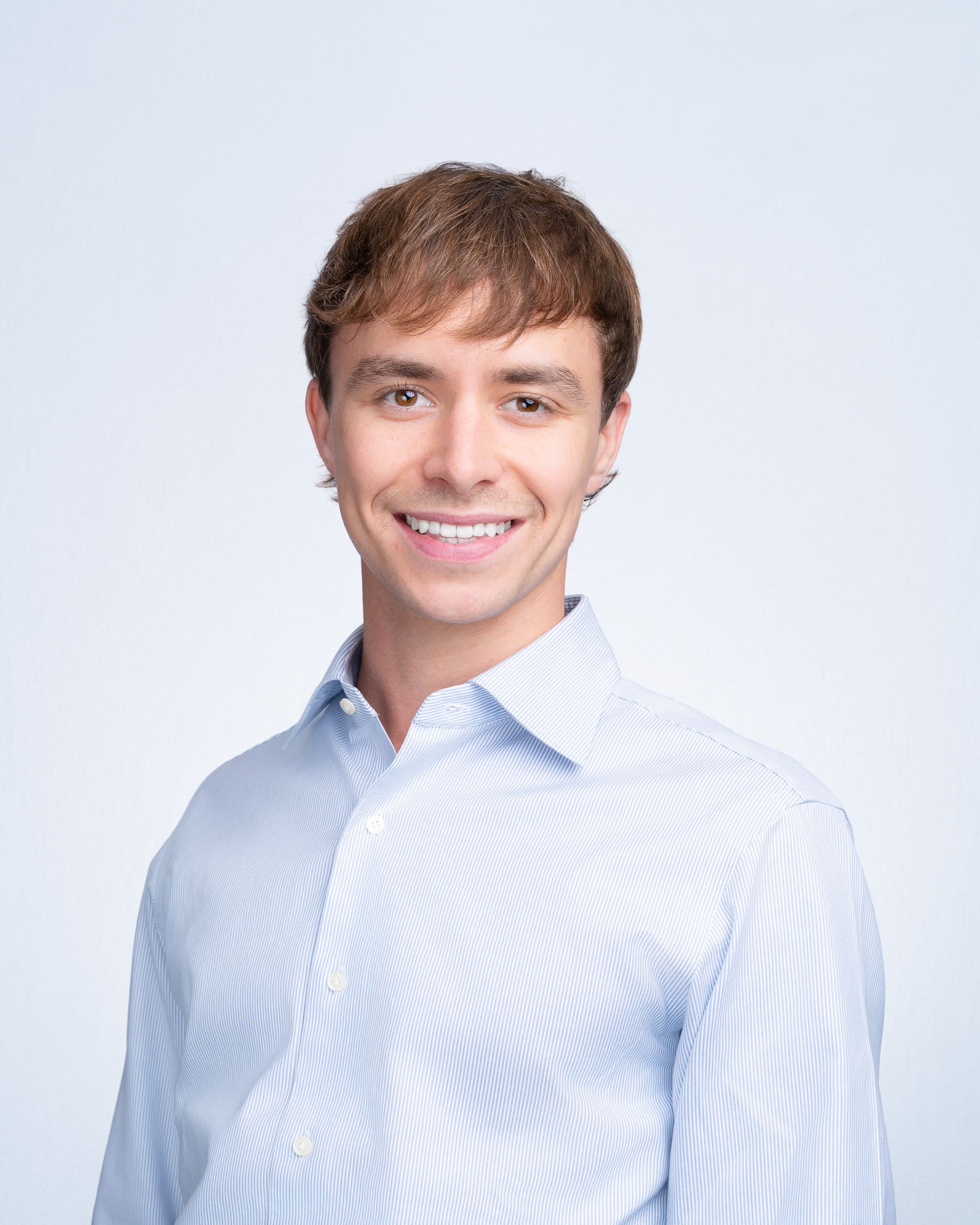 Team-Headshot-Sydney-NSW Young man wearing blue shirt having his team headshot taken by corporate photographer Georgie Greene