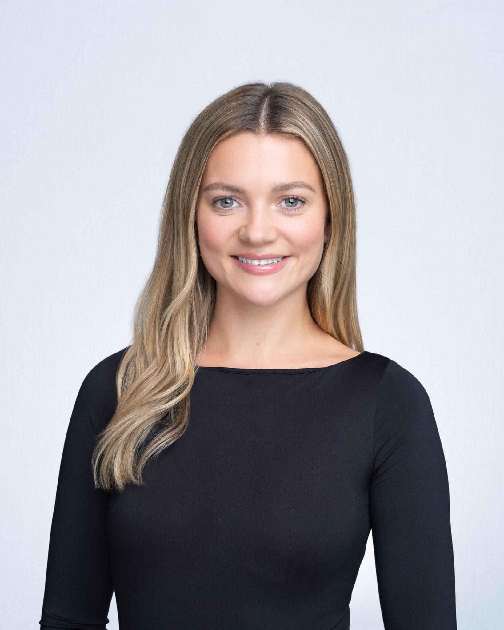 Young blonde woman wearing a black top having her team headshot taken by headshot photographer Georgie Greene