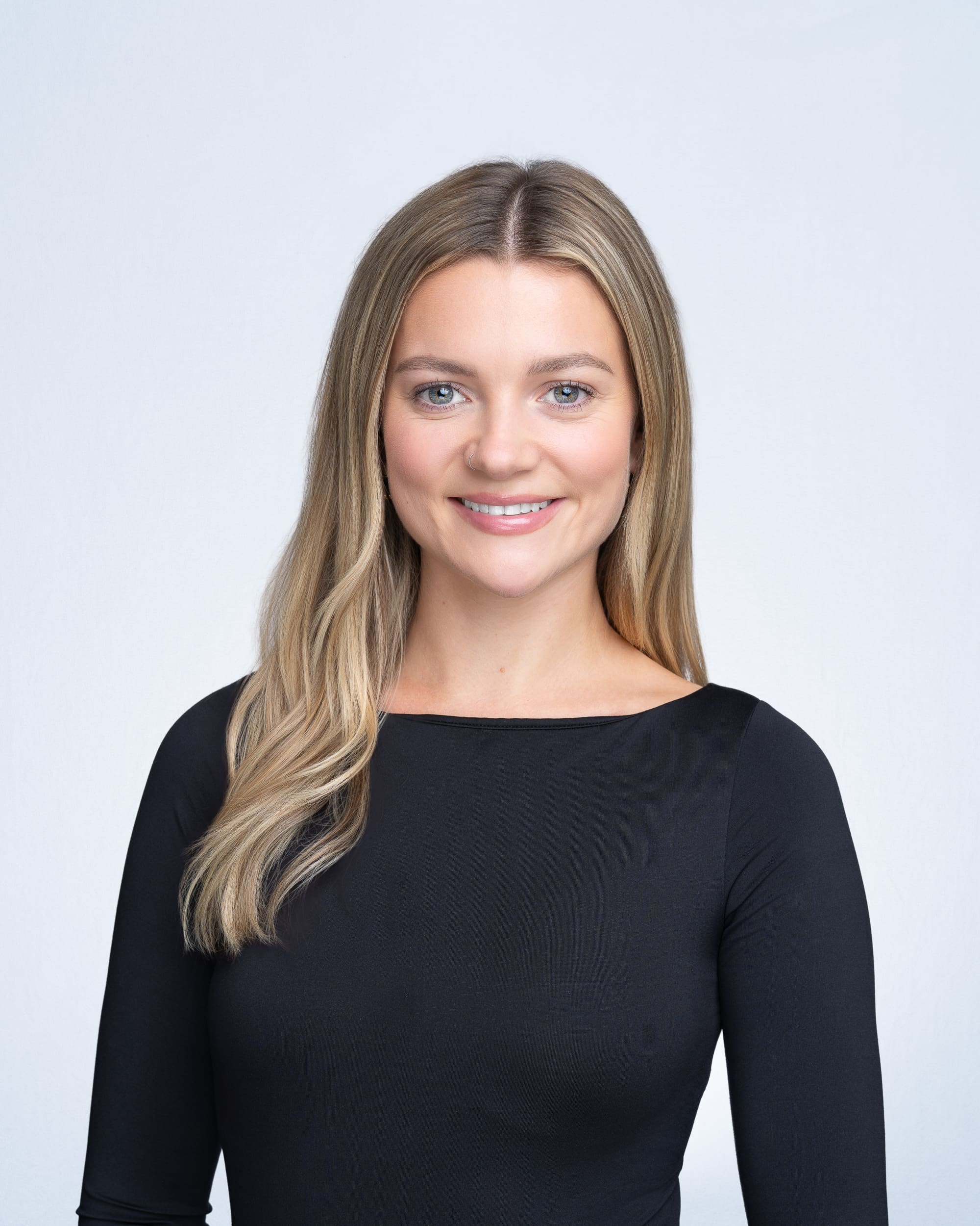 Team-Headshots-Sydney-NSW Young blonde woman wearing a black top having her team headshot taken by headshot photographer Georgie Greene