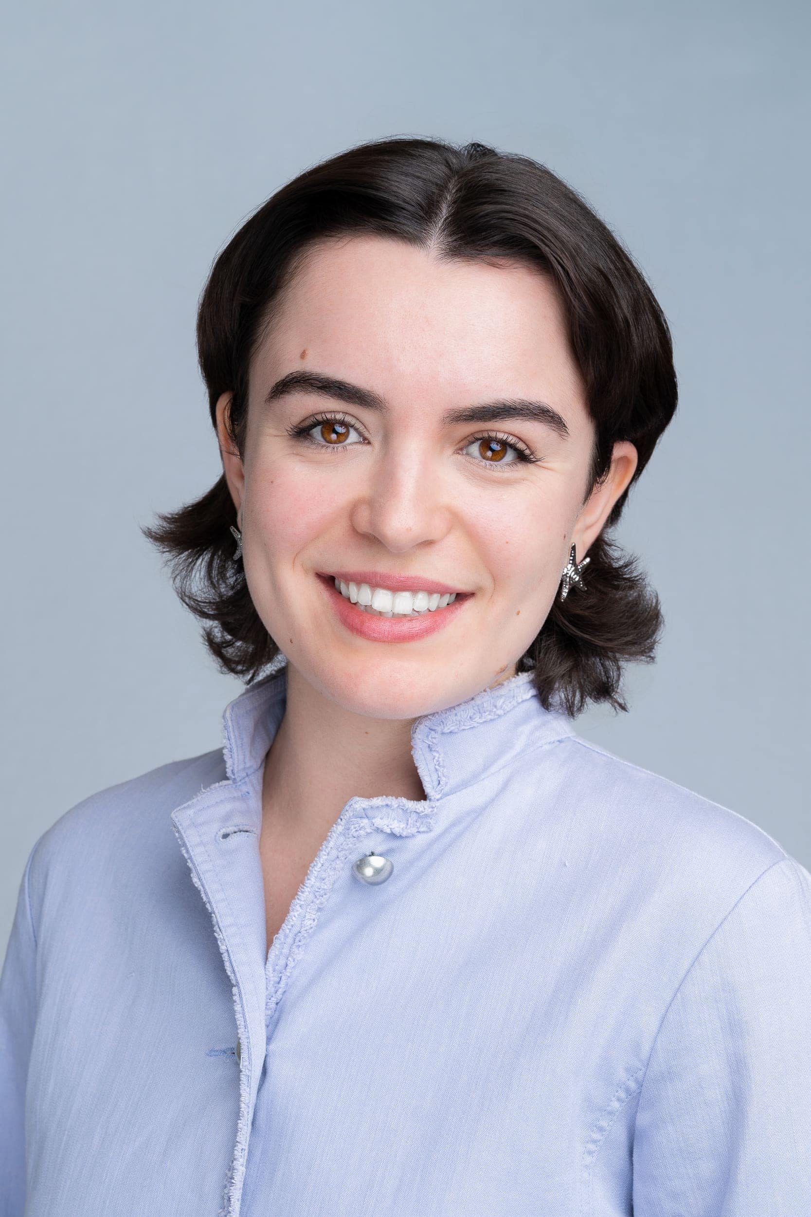 Environmentalist-Headshot-Sydney-NSW Young woman with dark hair in a blue blouse having her headshot taken by Sydney headshot photographer Georgie Greene