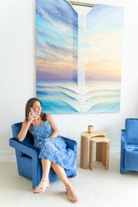 Sydney-Branding-Photography-Marketing-Specialist – Professional Photographer Sydney dark haired marketing specialist sitting on a blue chair on the phone having her personal branding photo taken by professional Sydney photographer Georgie Greene