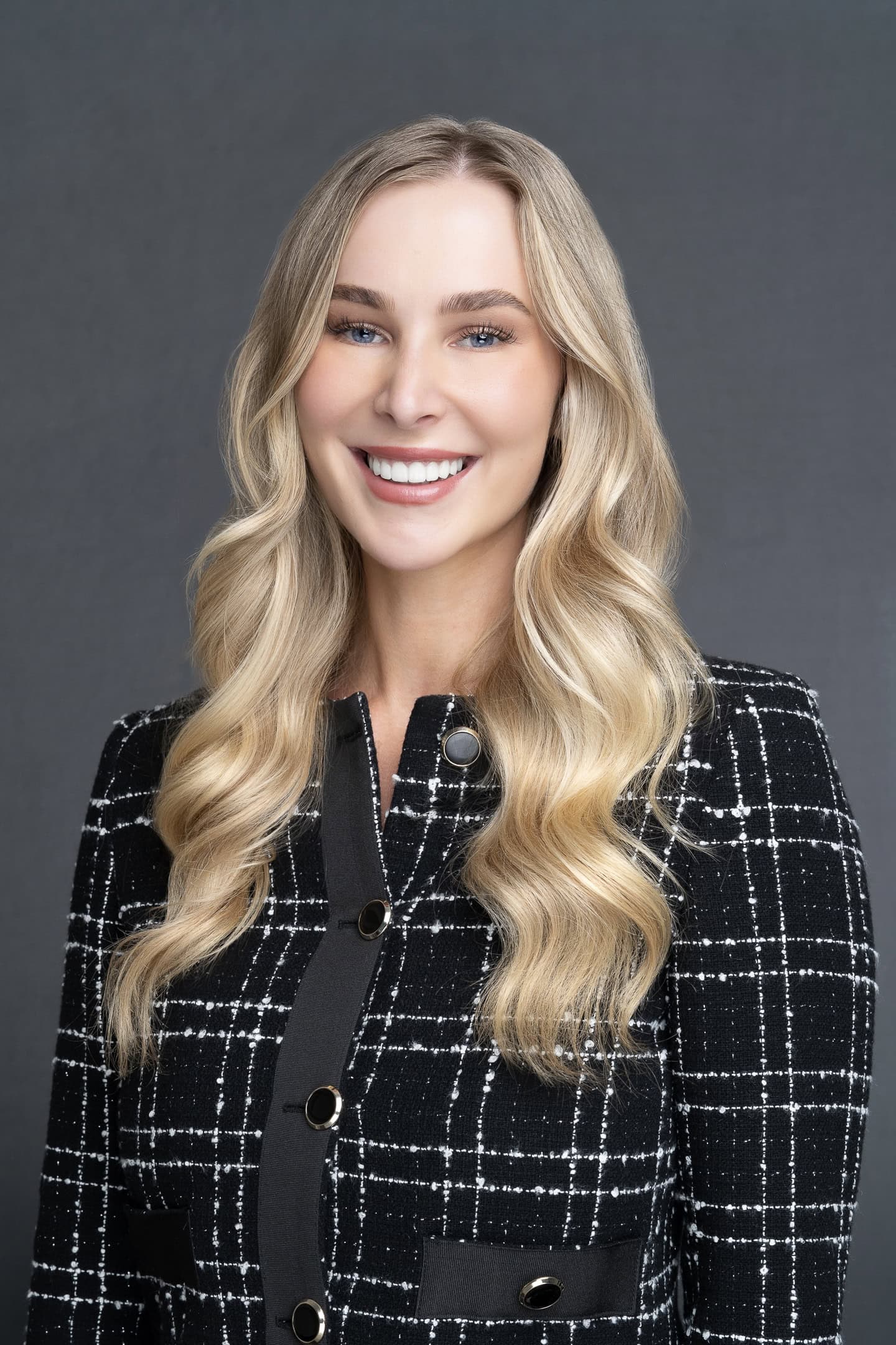 Sydney headshot of young blonde woman wearing a checked jacket