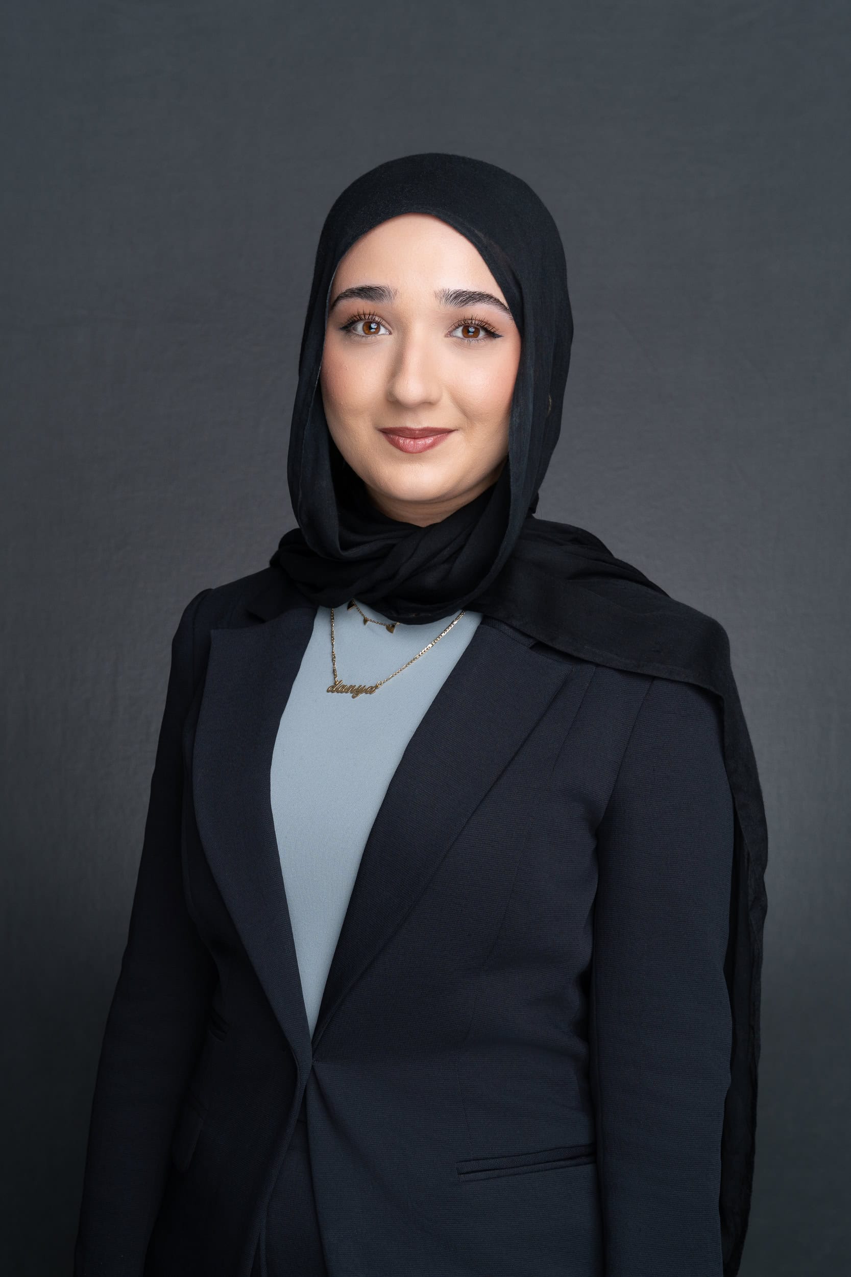 Woman wearing a black head scarf having her headshot taken by Sydney professional photographer Georgie Greene