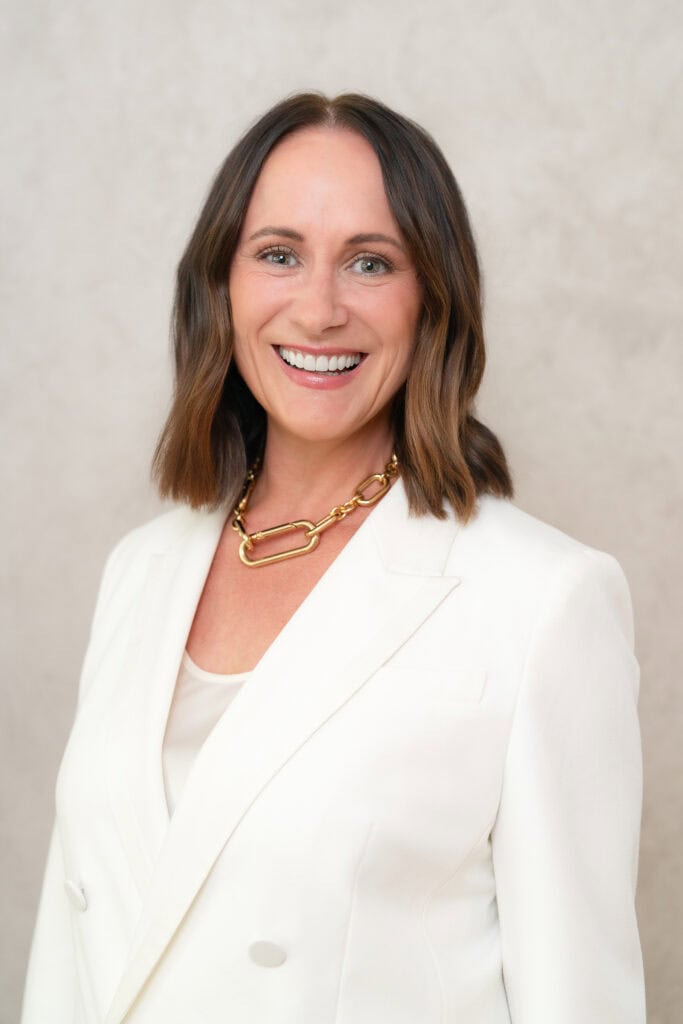 Young brunette woman wearing a white suit having her headshot taken by Sydney professional photographer Georgie Greene