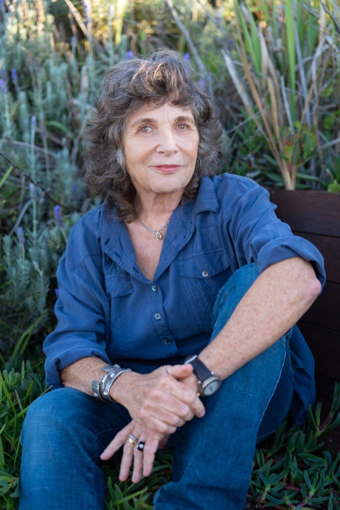 Book author in a blue shirt and jeans having her professional headshot taken for a book launch by professional Sydney photographer Georgie Greene