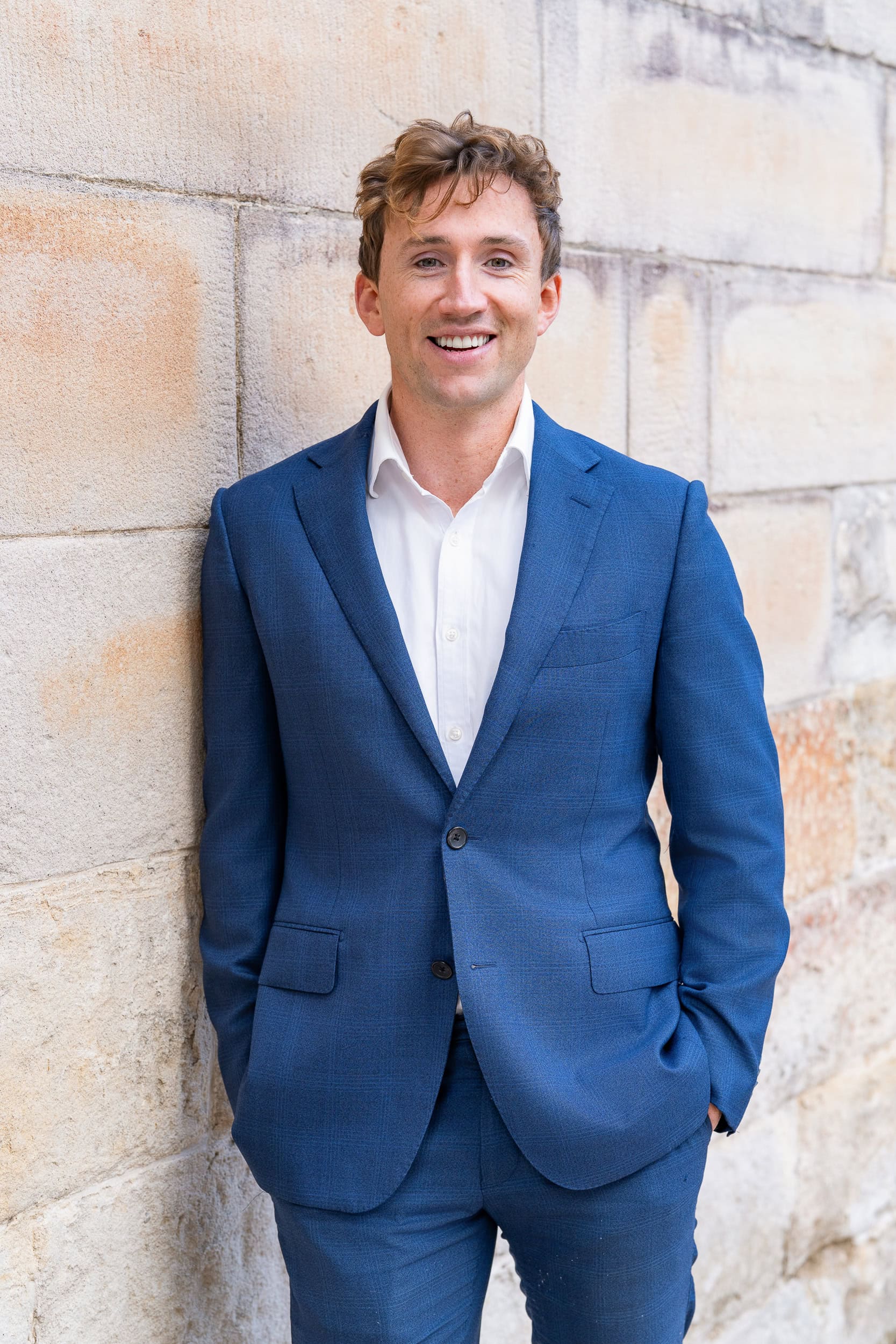 young business man in a blue suit having his corporate headshots taken by Sydney professional headshot photographer Georgie Greene
