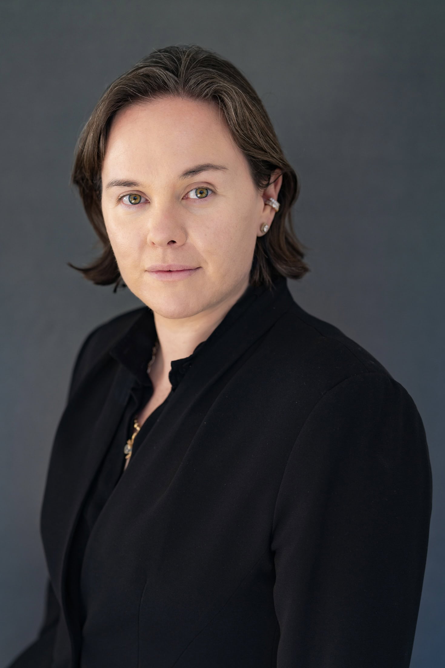 young finance executive wearing black having her professional headshot taken by Sydney headshot photographer Georgie Greene