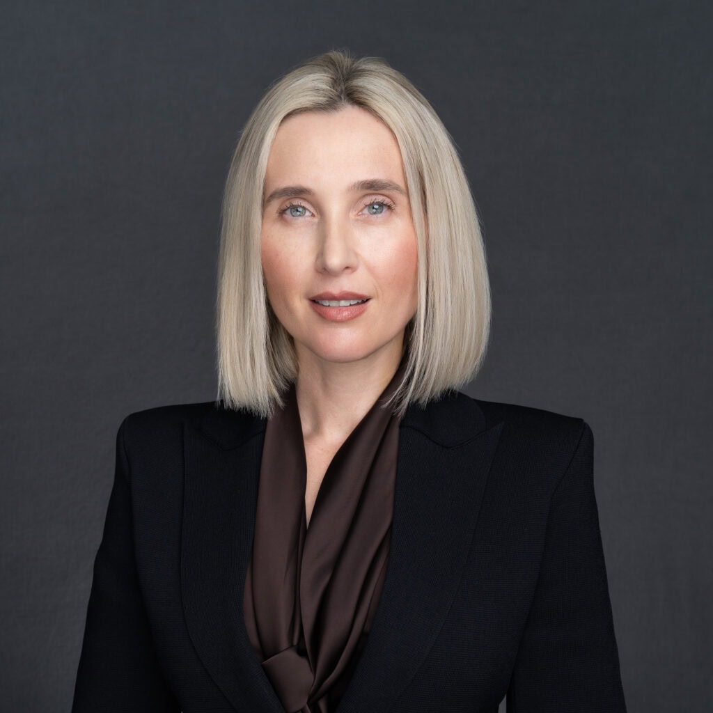 blonde woman in a black jacket having her professional headshot taken by headshot photographer Georgie Greene