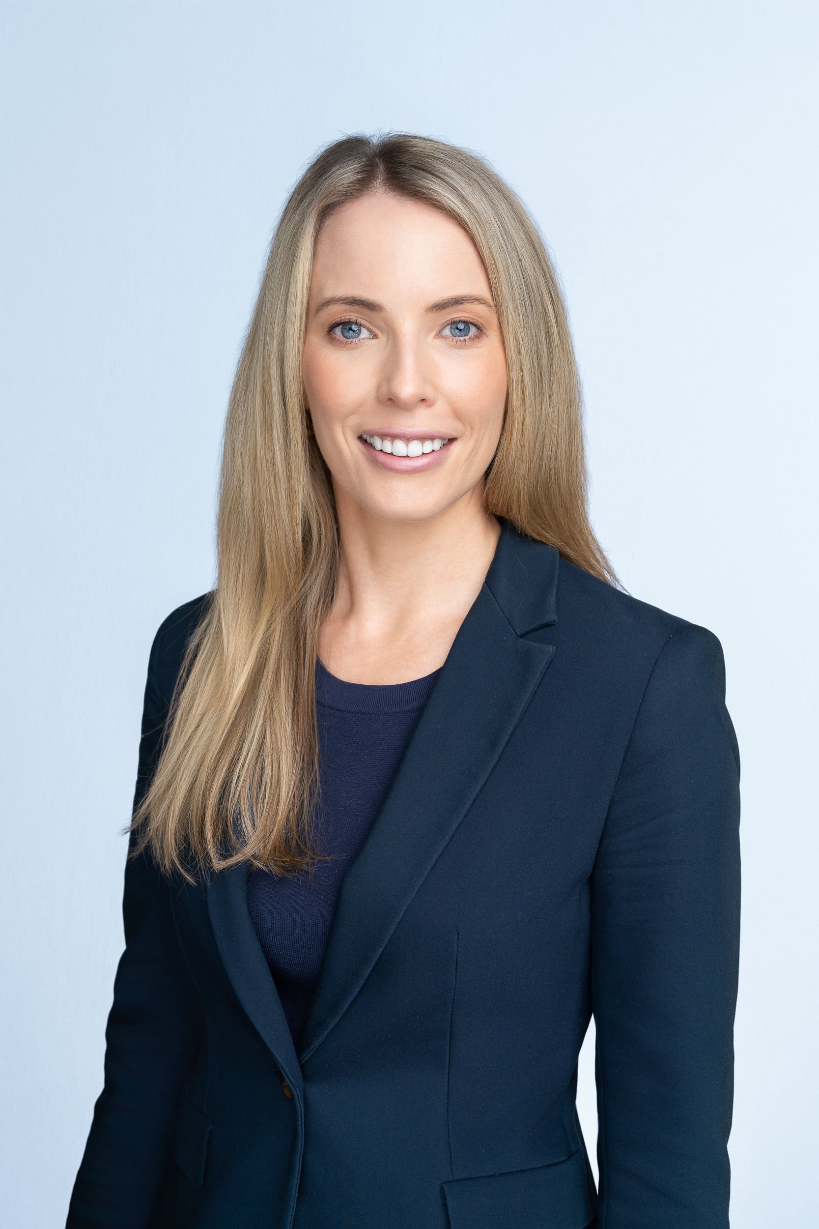 young blonde professional woman in a blue jacket having her professional headshot by Sydney headshot photographer Georgie Greene