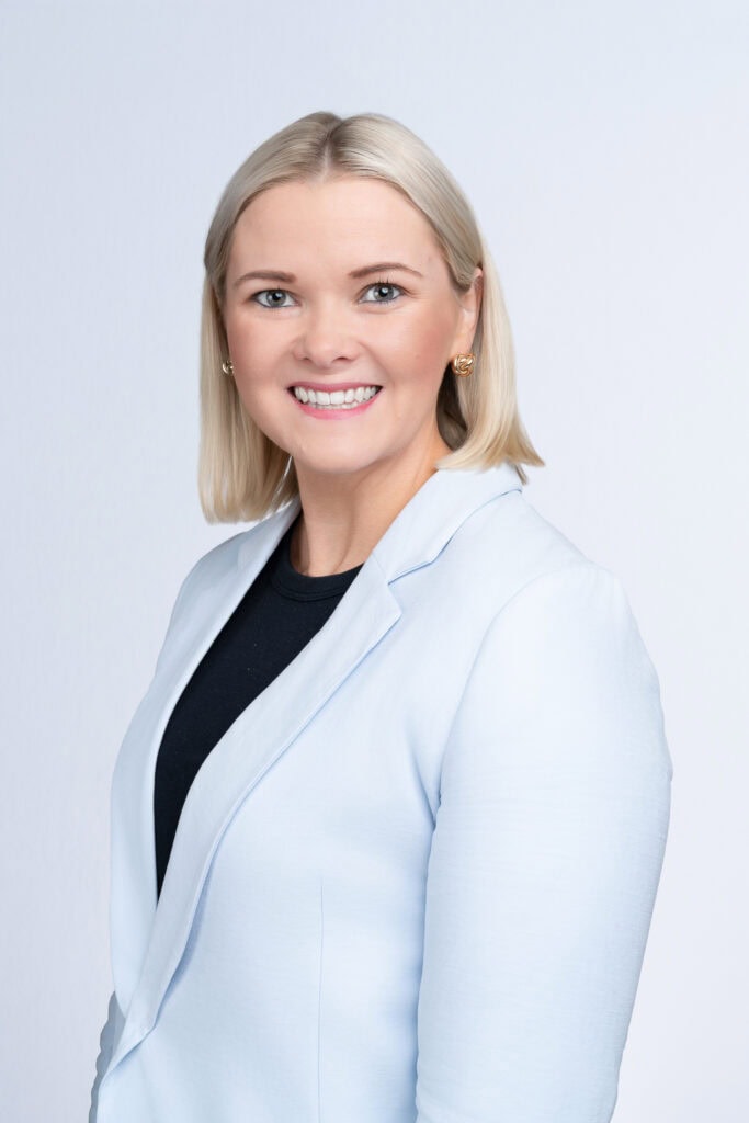 blonde professional woman wearing a blue jacket having her corporate headshot taken by professional Sydney photographer Georgie Greene