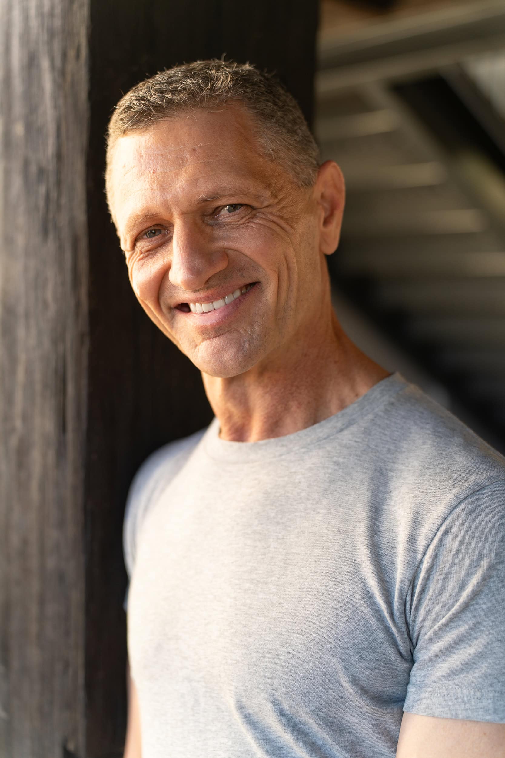 older man in a grey t-shirt having his dating photo taken by Sydney dating photographer Georgie Greene