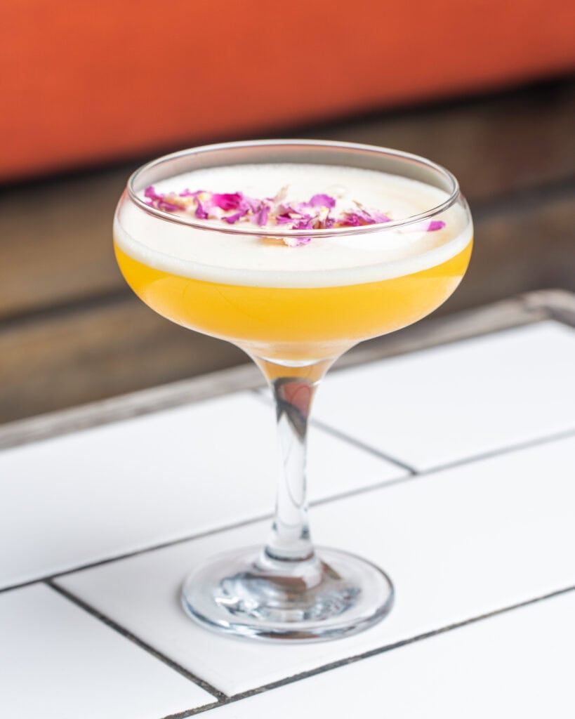 Cocktail with rose petals on the top