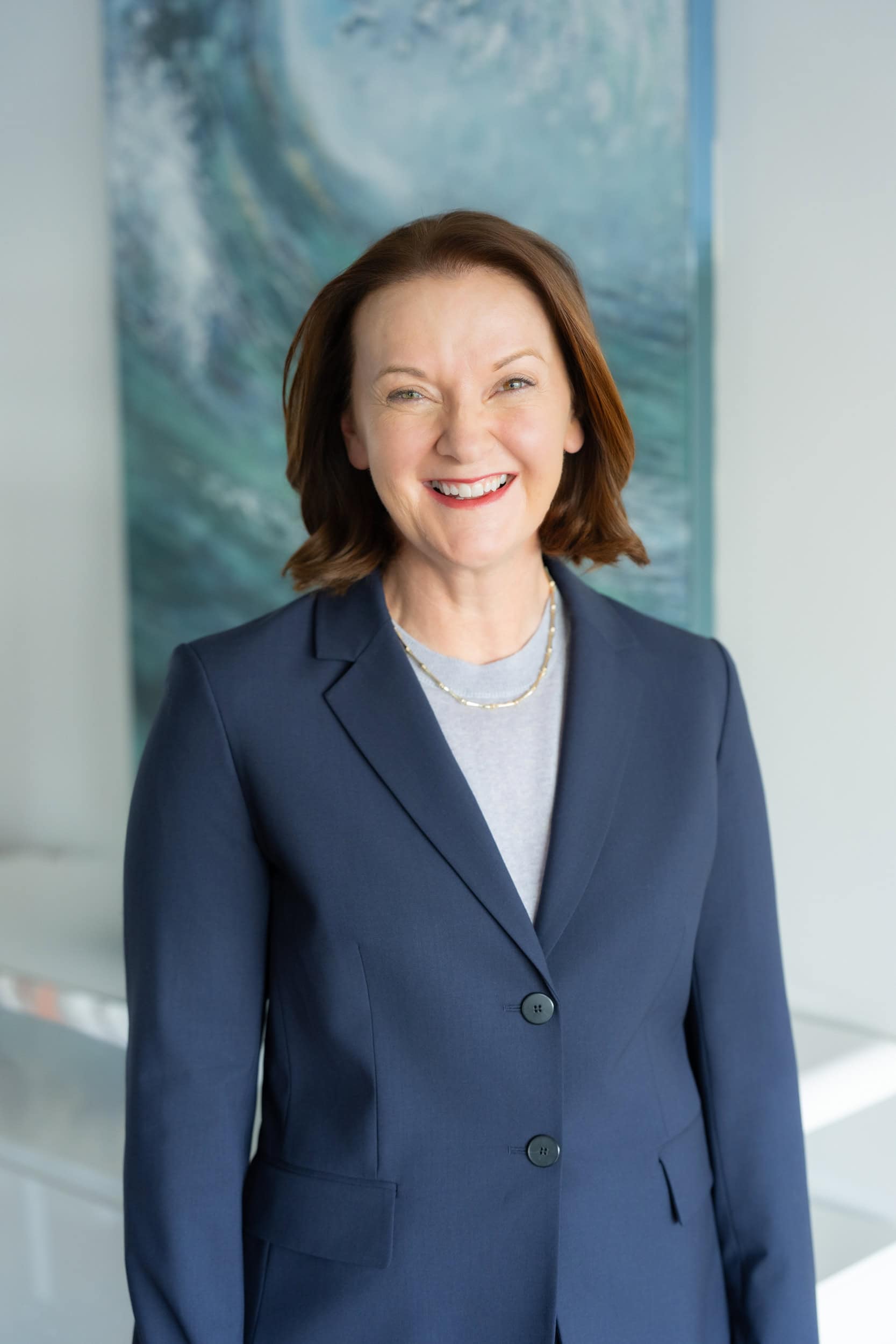 dark haired professional woman wearing a blue jacket