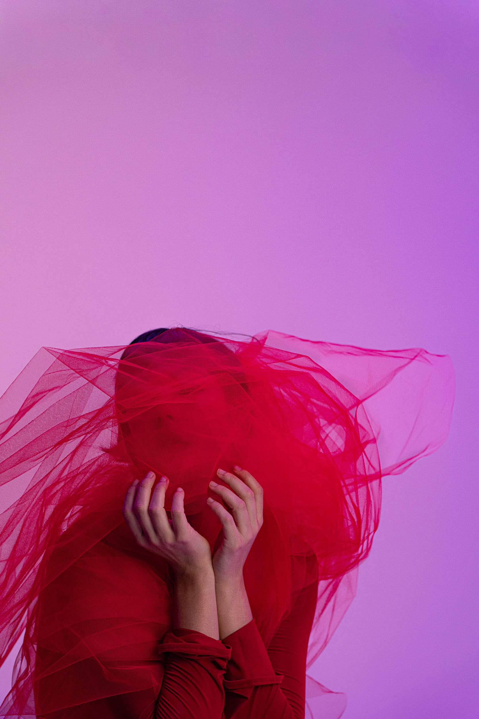 woman behind a red veil